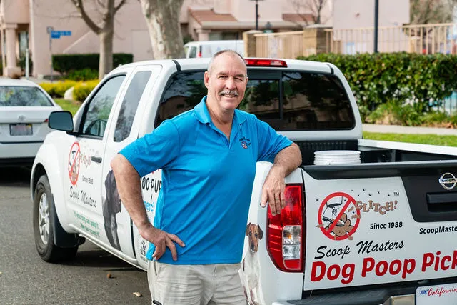Image of timothy stone, founder of scoop masters dog poop pick up service in los angeles, and one of the pooper scooper business work trucks.